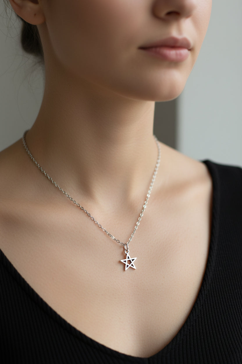 Star pendant necklace on a model with a plain background