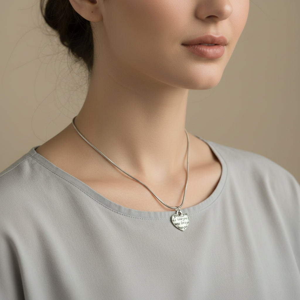 Silver heart-shaped pendant necklace on a model
