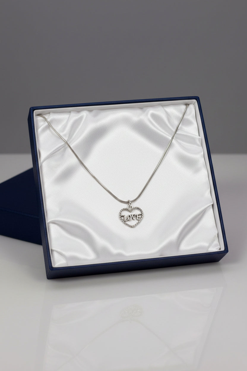Silver necklace with a heart-shaped pendant in a dark blue gift box