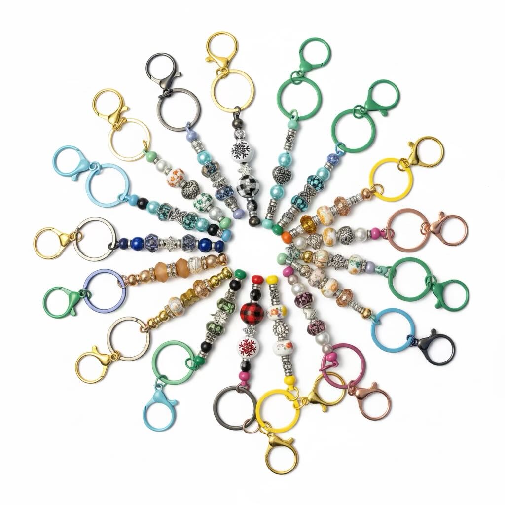 A collection of colorful beaded keychains arranged in a circular pattern on a solid white background.