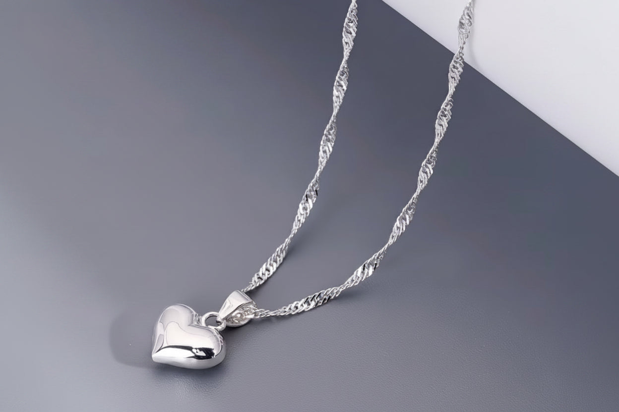 Heart pendant necklace on greyand white background