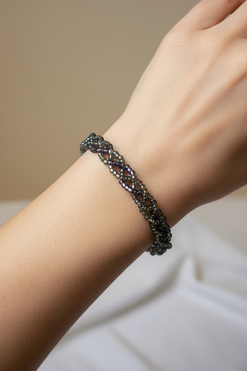 elasticated platted black/grey/purple bracelet on a model's arm