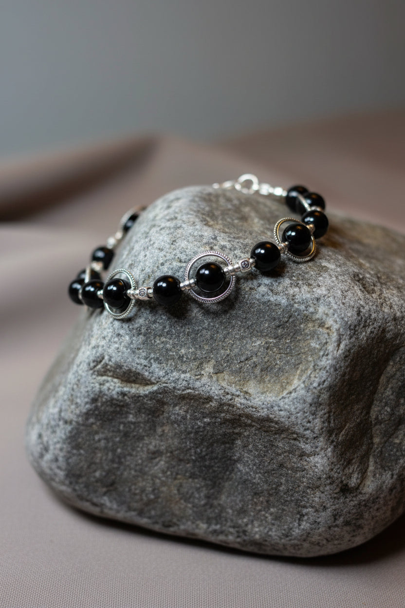 Black pearl bracelet on a large grey stone 