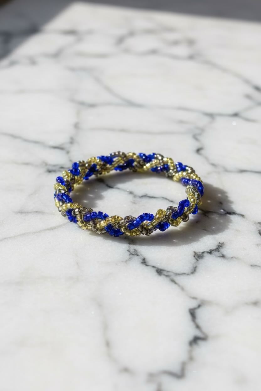Blue beaded bracelet on a marble surface