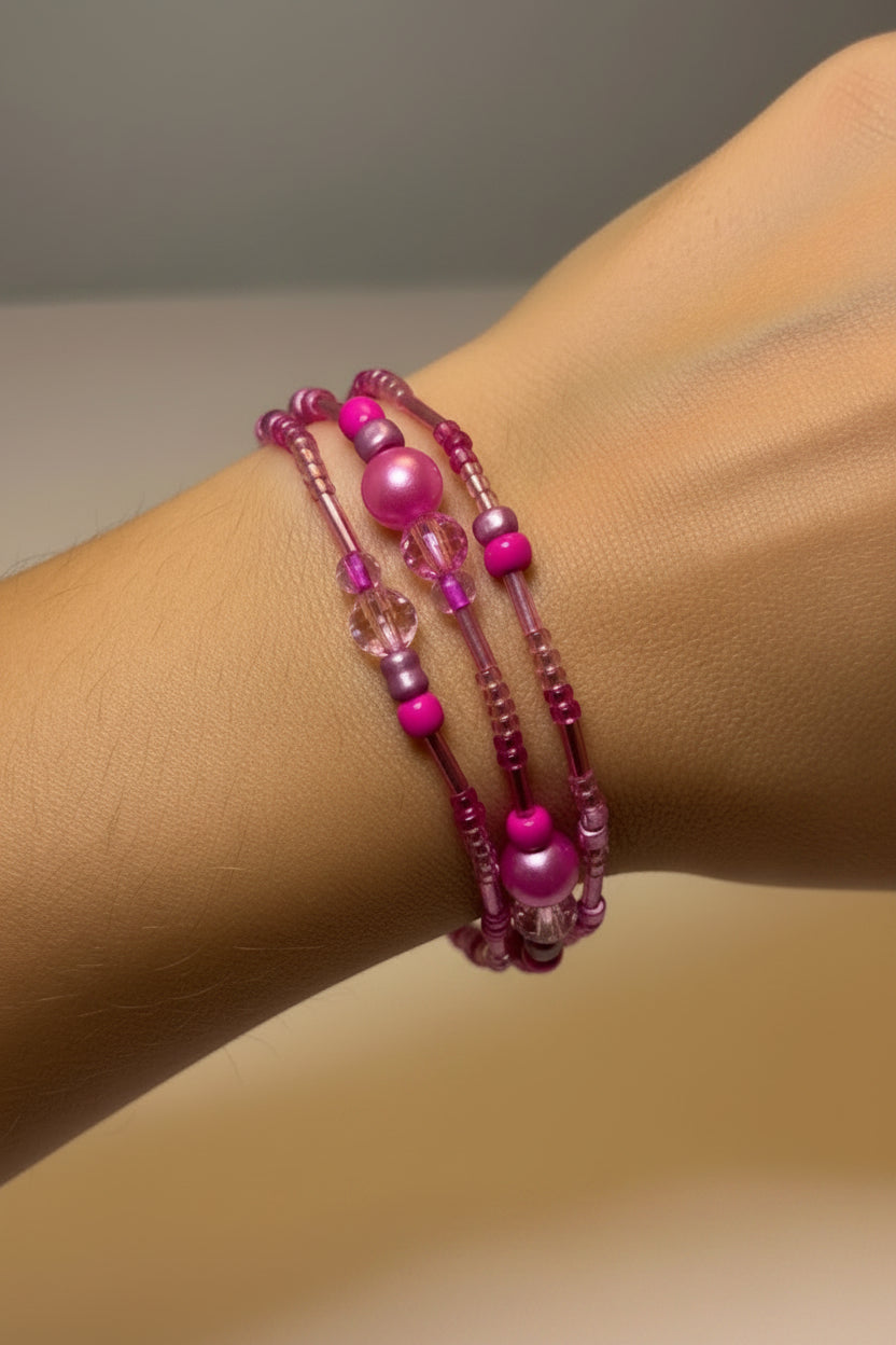Pink beaded triple bracelet set on a model's arm