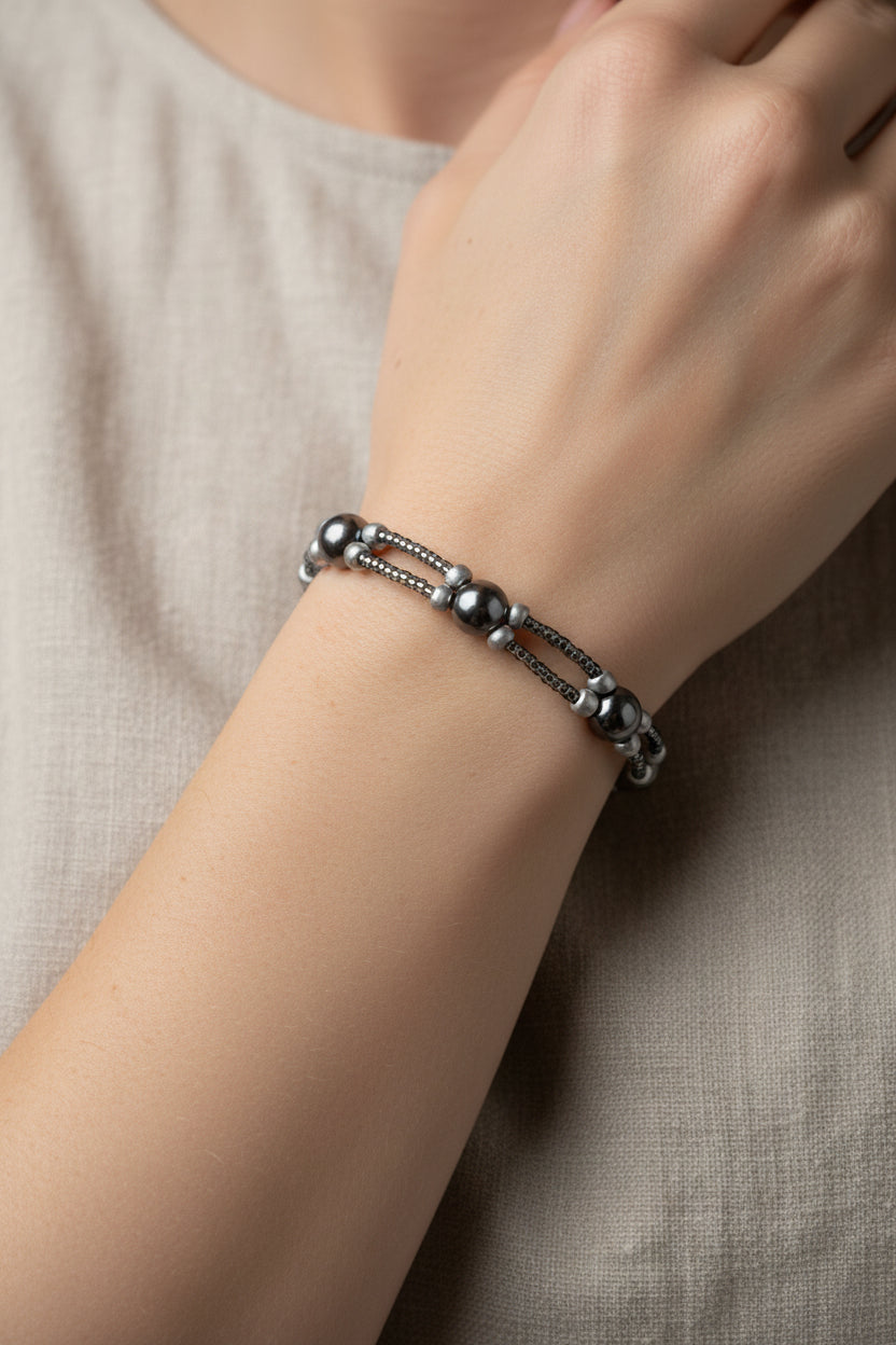 Grey pearl bracelet on a model's arm