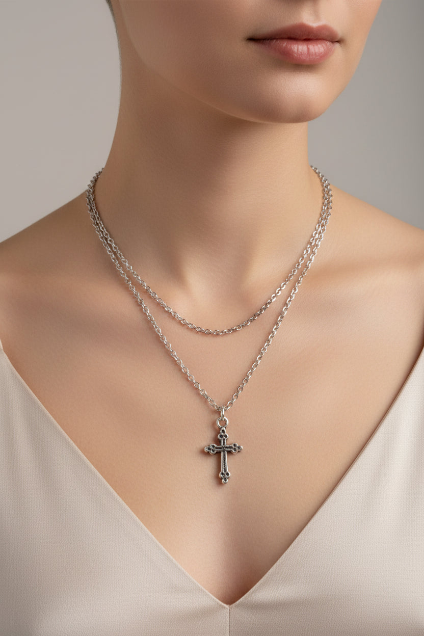Silver chain necklace with a cross pendant on a model