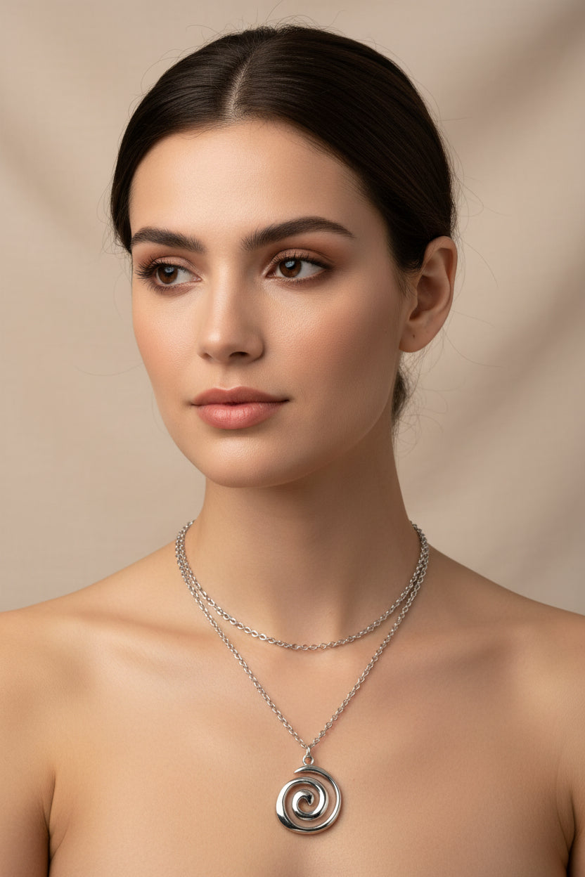 Silver spiral pendant necklace on a model
