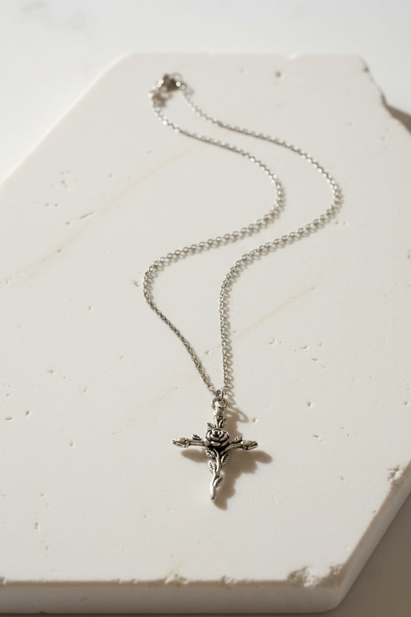 Silver necklace with a cross pendant on a large white stone