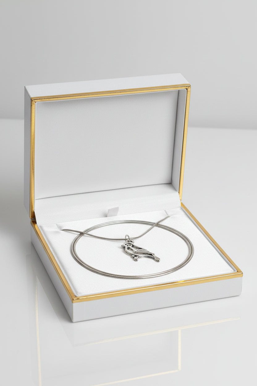 Silver bird pendant on a chain in a gift box