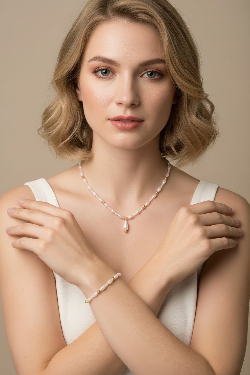 A delicate beaded necklace and matching bracelet displayed on a model