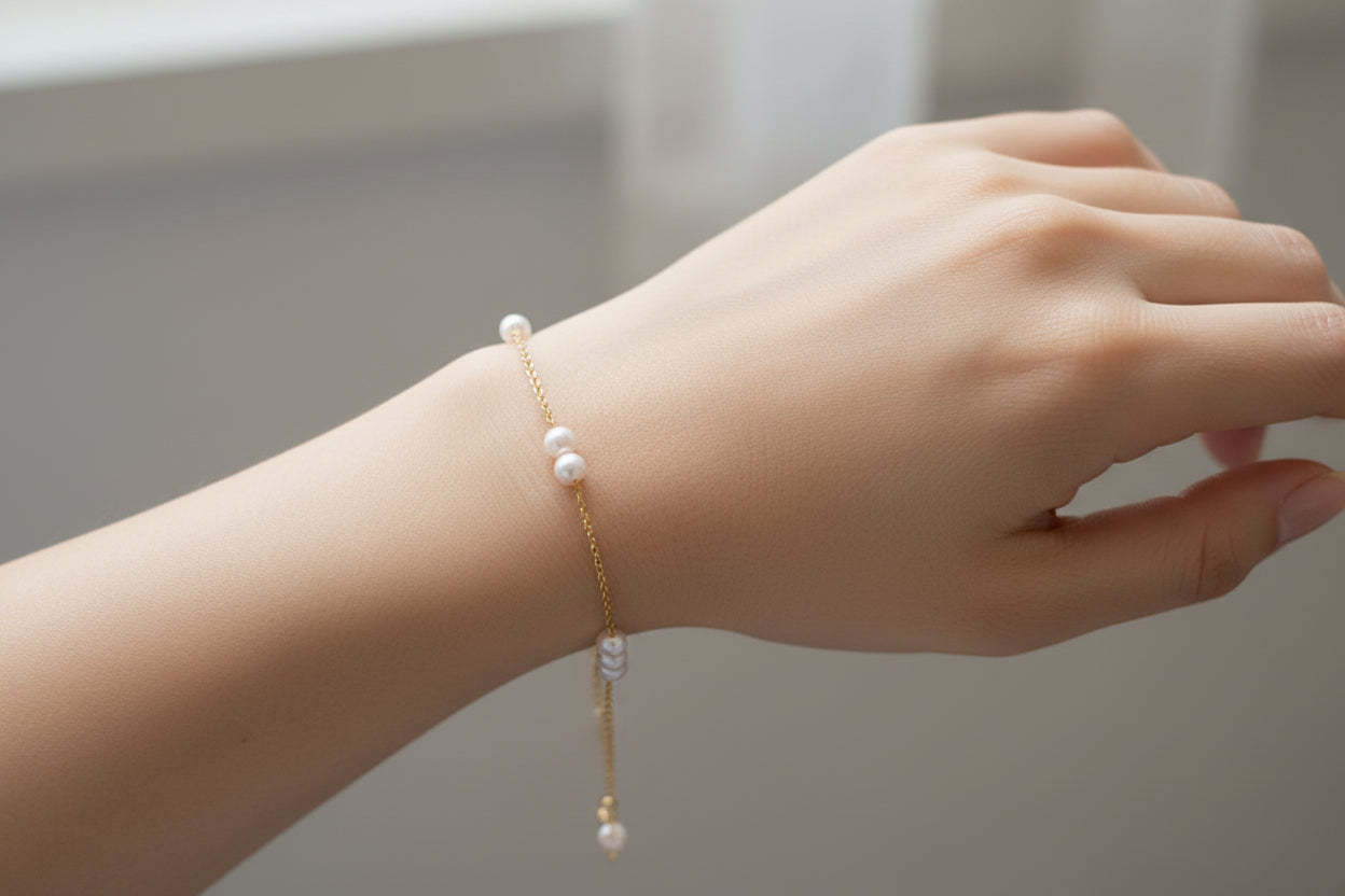 Gold bracelet with pearls on a model
