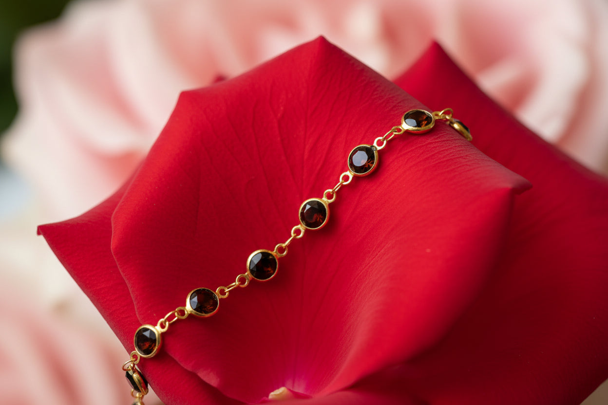 Gold bracelet with embedded stones on a large rose petal 