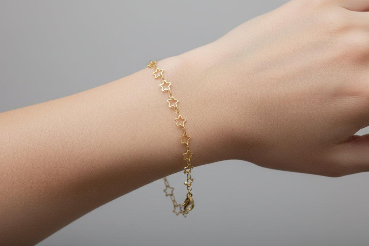 Gold star-shaped bracelet on a model's wrist