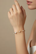 Gold pearl bracelet on model's arm
