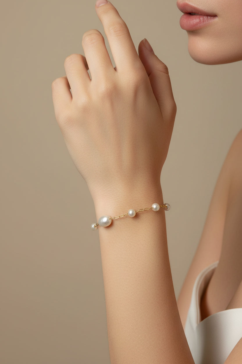 Gold pearl bracelet on model's arm