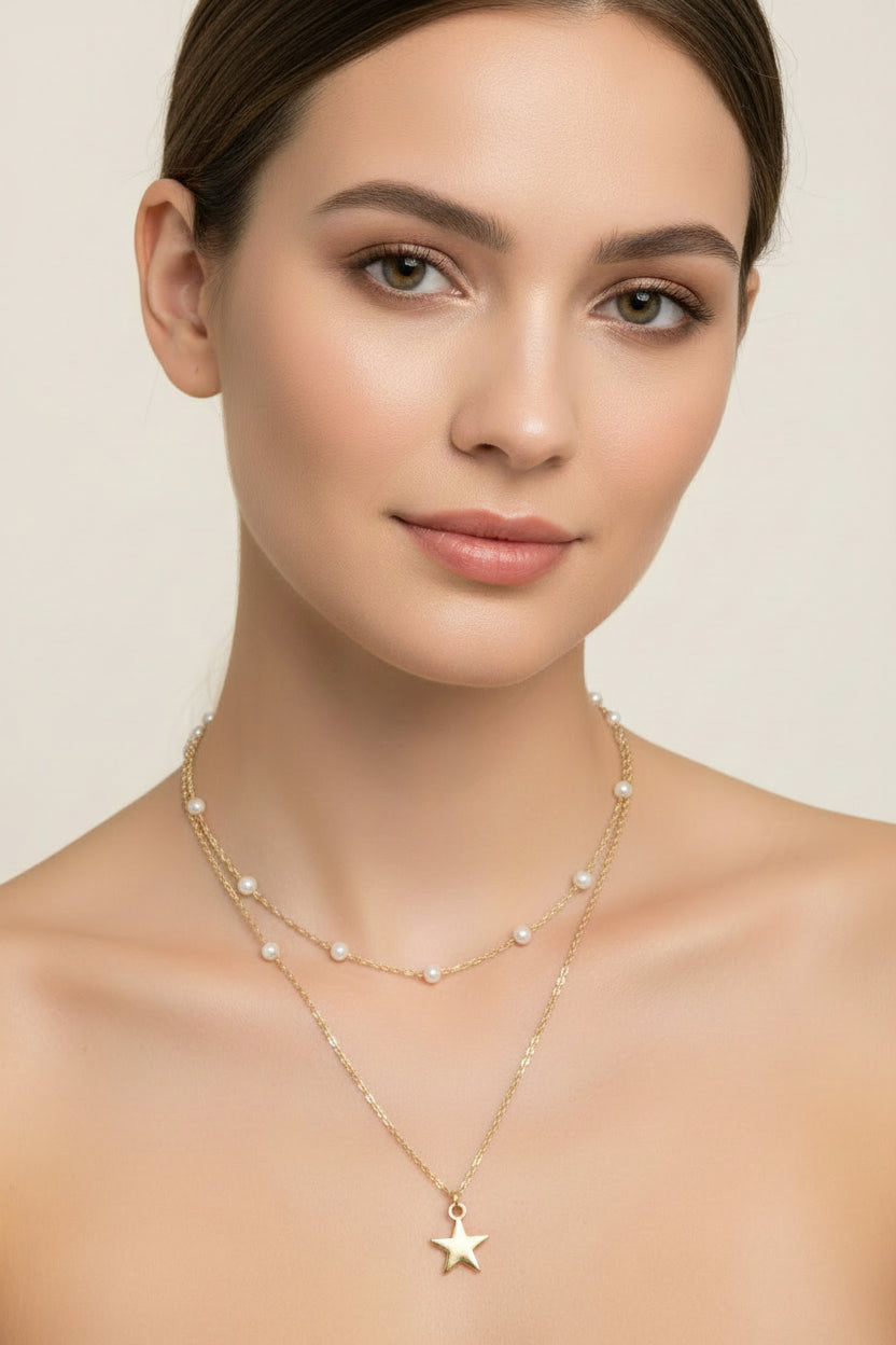 Gold necklace with a star pendant on a model