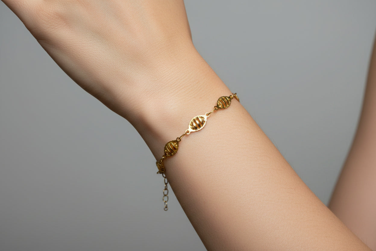 Gold bracelet on a model's arm