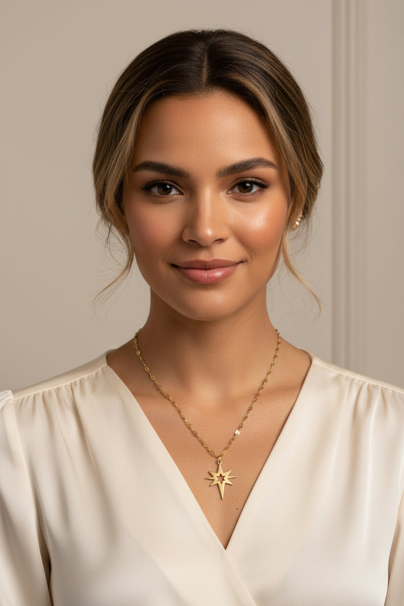 Gold necklace with a star pendant on a model