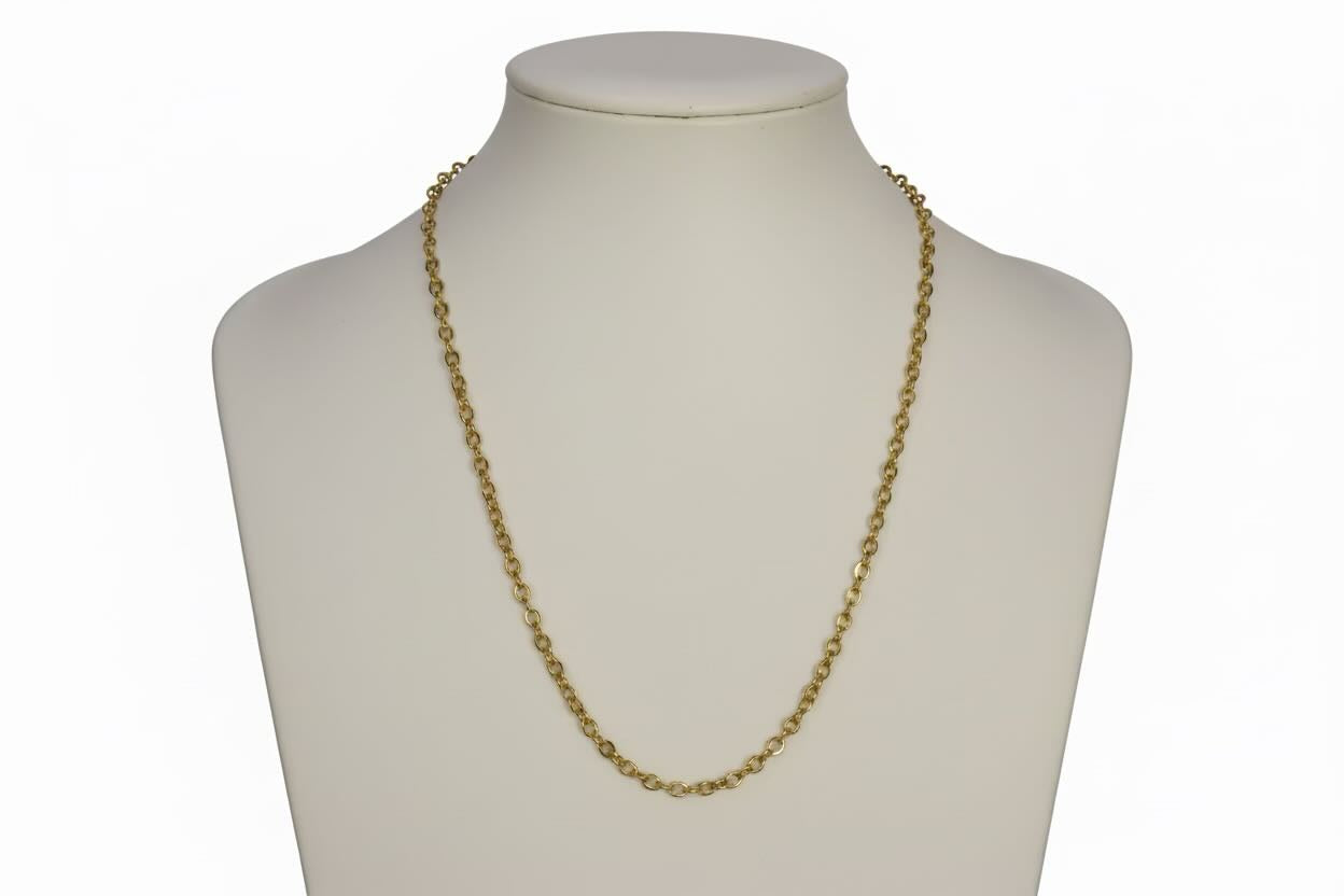 Gold chain necklace on a mannequin bust against a white background