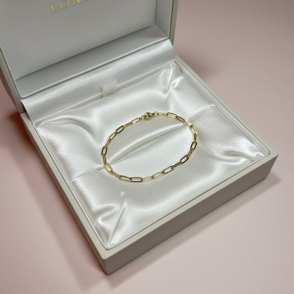 Gold chain bracelet in a white gift box