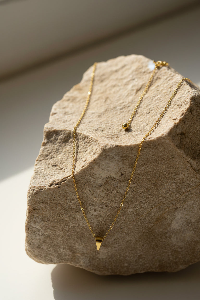 Gold necklace on a large stone