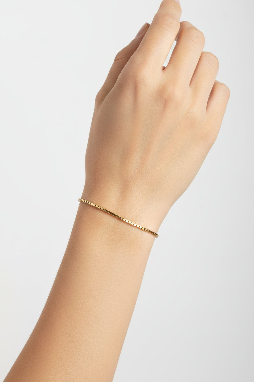Gold box chain bracelet on a model's arm