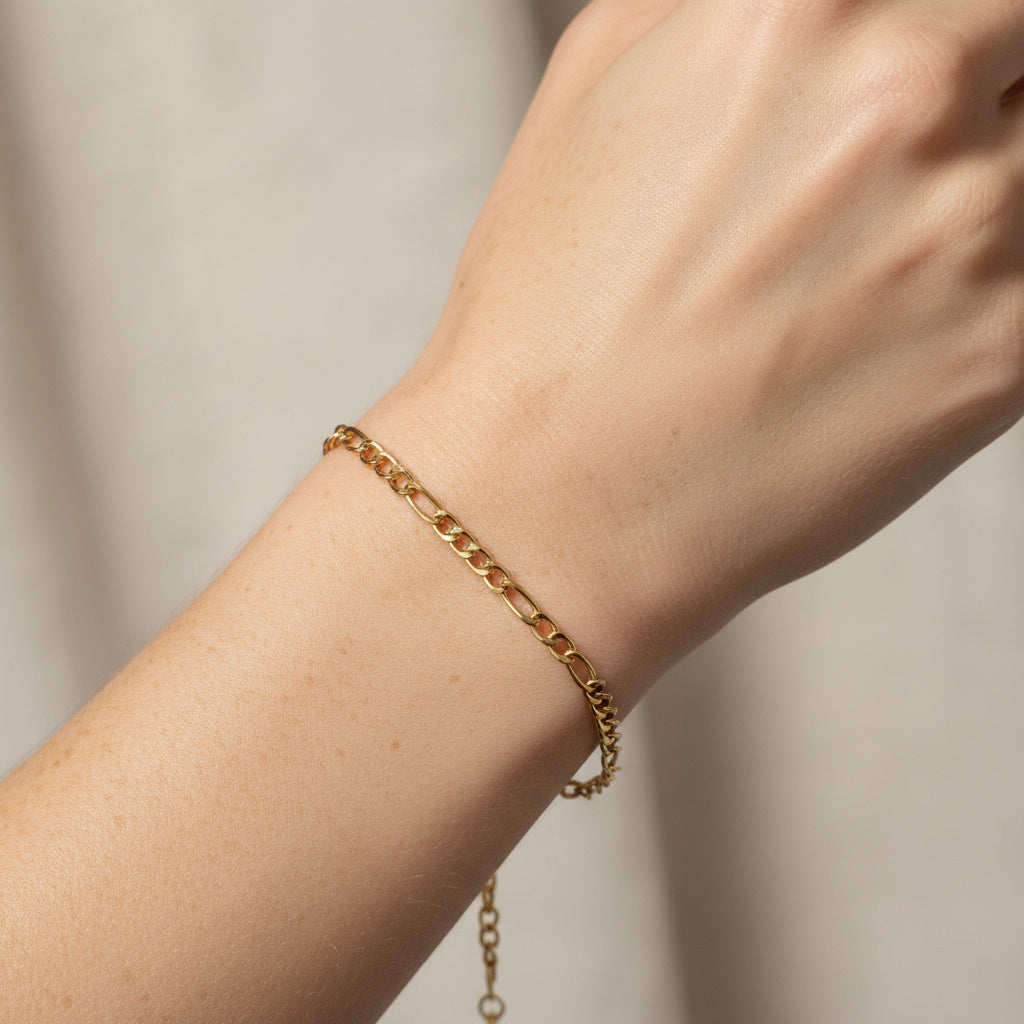 Gold chain bracelet on a white model's arm