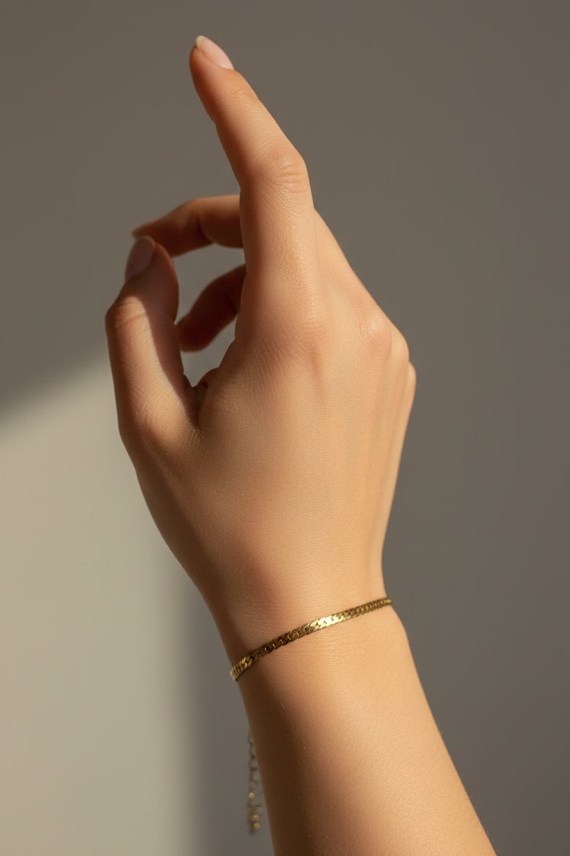 Gold chain bracelet on a white model