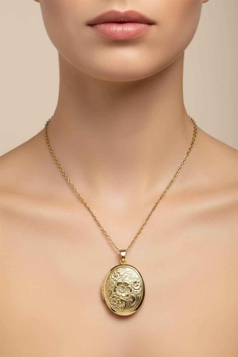Gold oval flowered locket necklace with a decorative on a model's neck