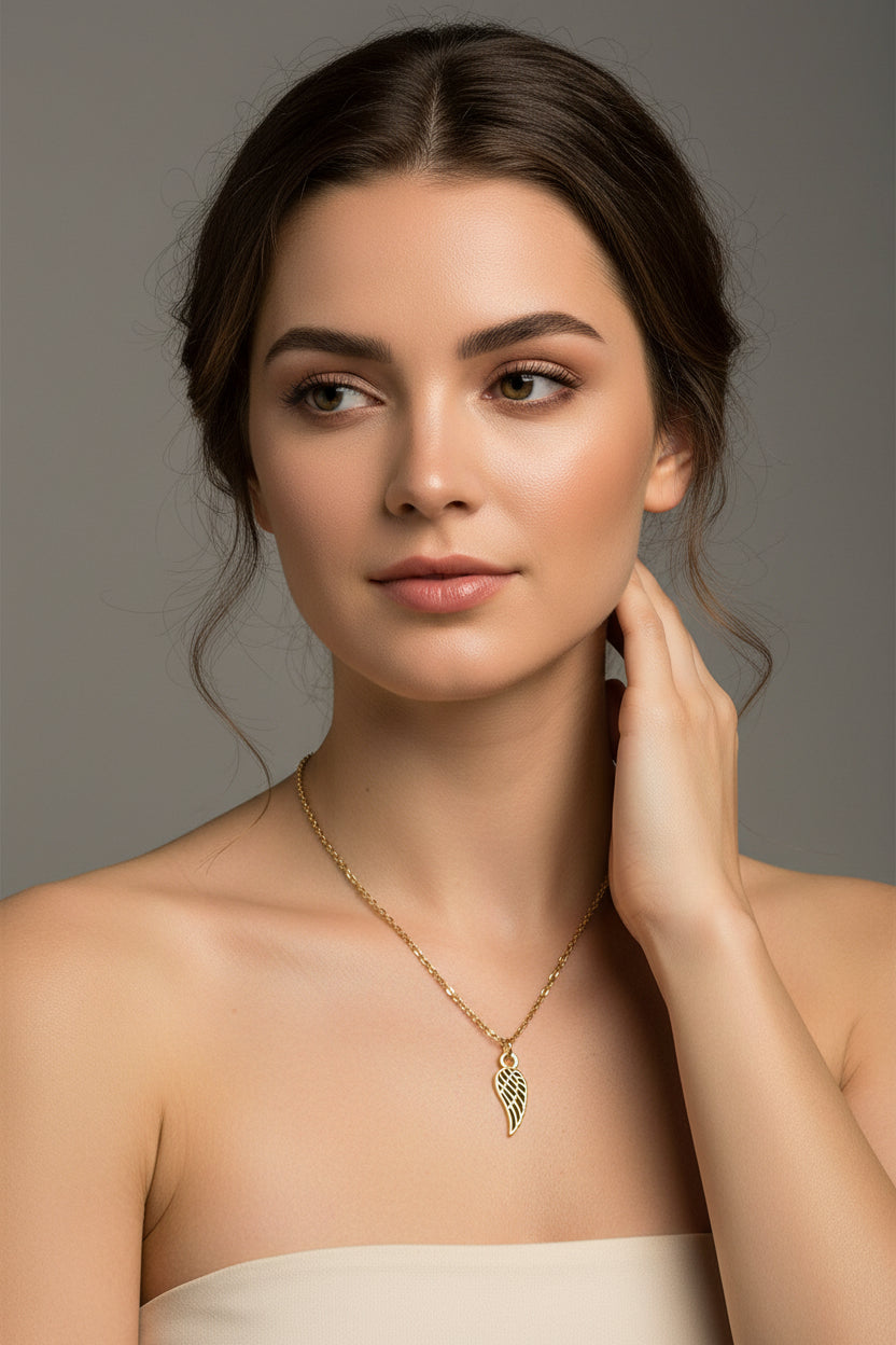 Necklace with a gold angel wing pendant on a model