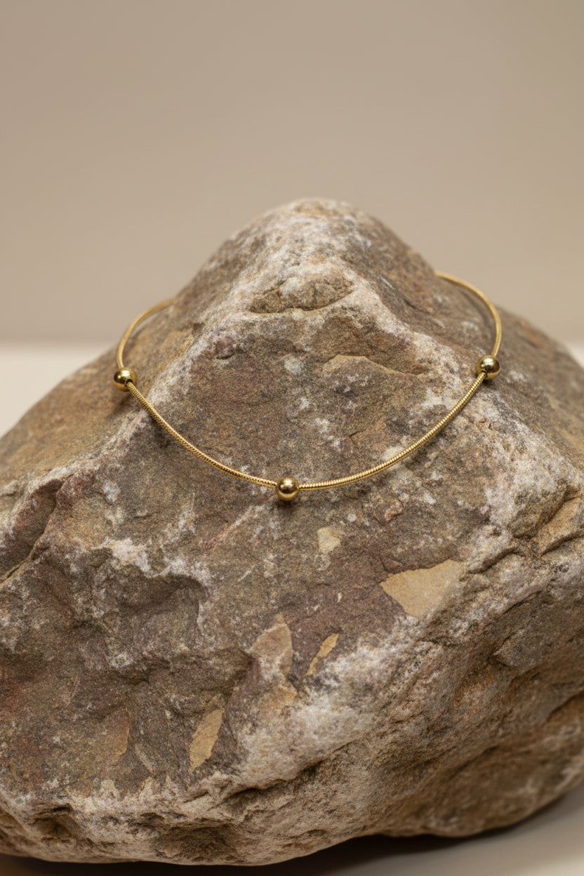 Gold bracelet on a large brown stone 
