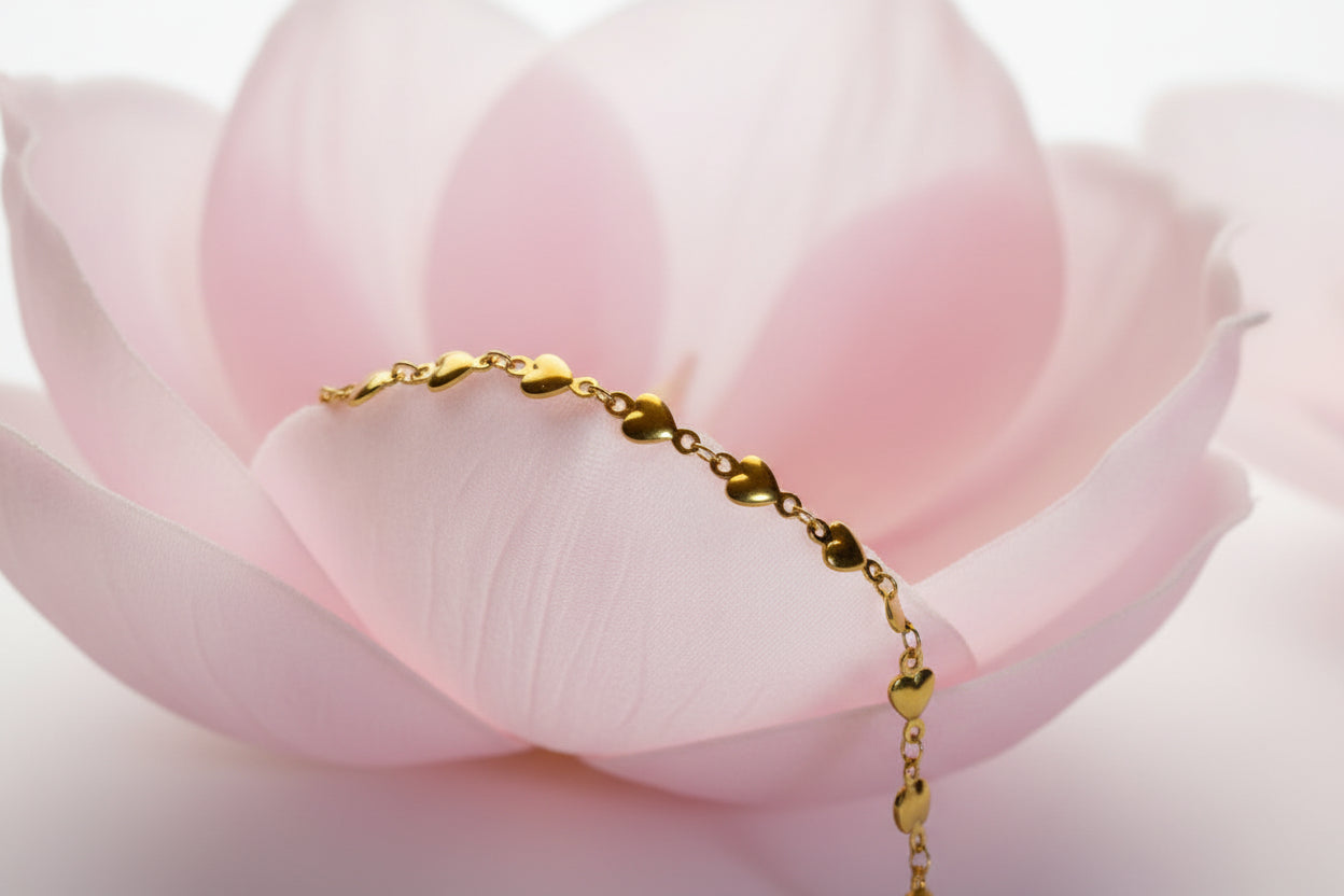 Gold bracelet on a large pale pink petal