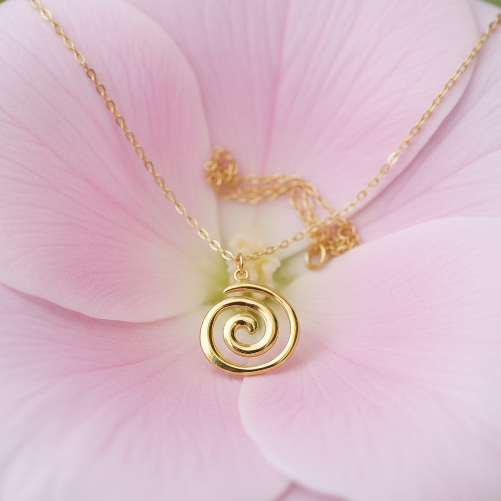 Gold spiral pendant necklace on a large petal