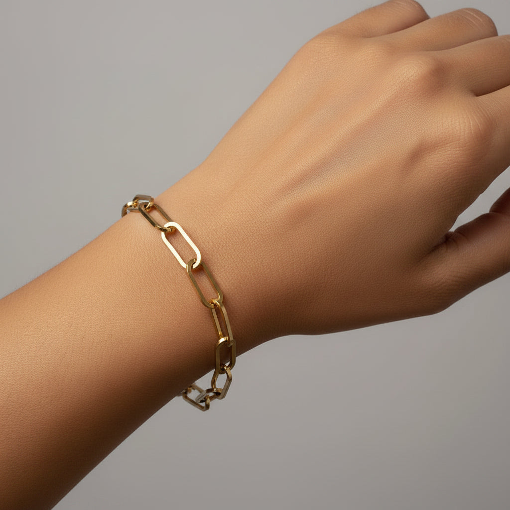 Gold chain bracelet on a white model in a white background