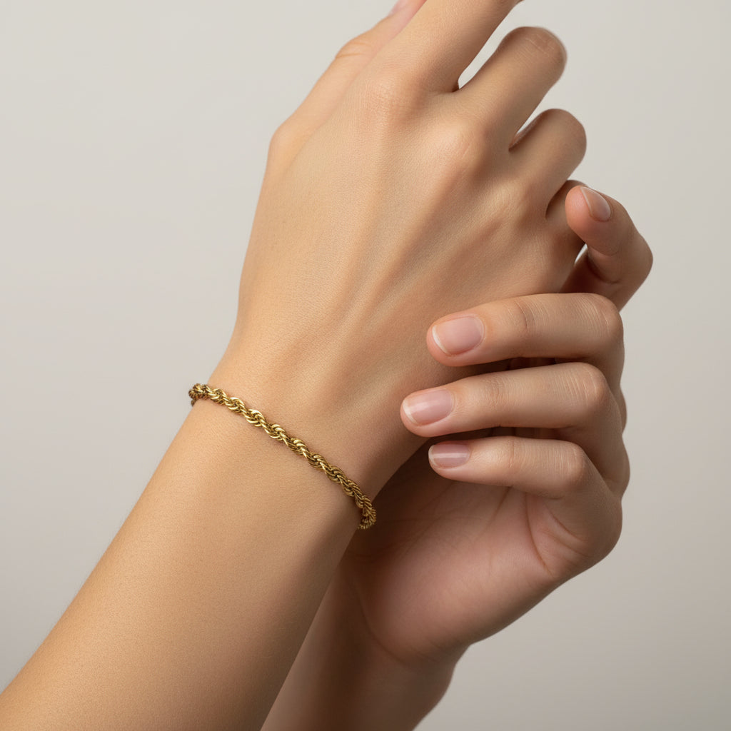 Gold chain bracelet on a model's arm