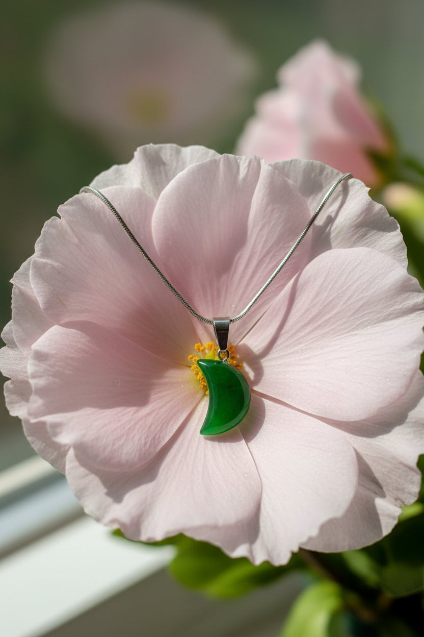 Green pendant necklace on a large pink flower 