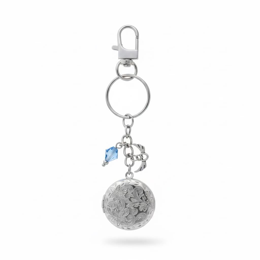 A silver-toned metal keyring/keyrings featuring a textured spherical locket, a small blue faceted crystal, and a lobster clasp on a clean white background.