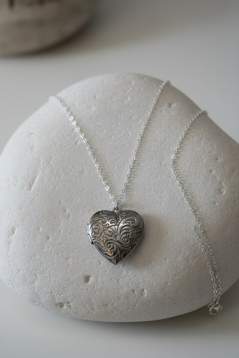 Silver heart-shaped pendant necklace on a large white stone