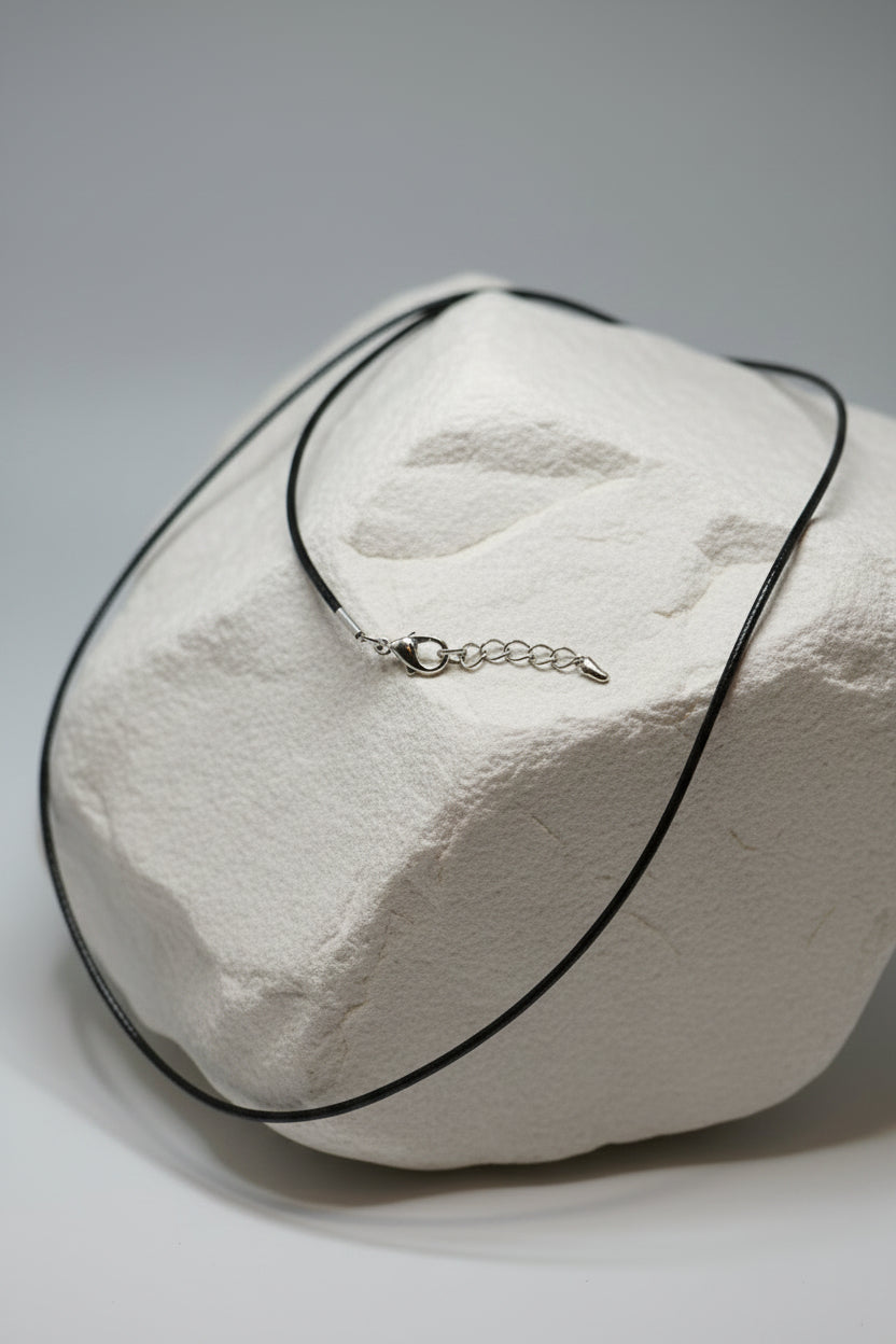 Necklace with a pendant and chain on a large white stone