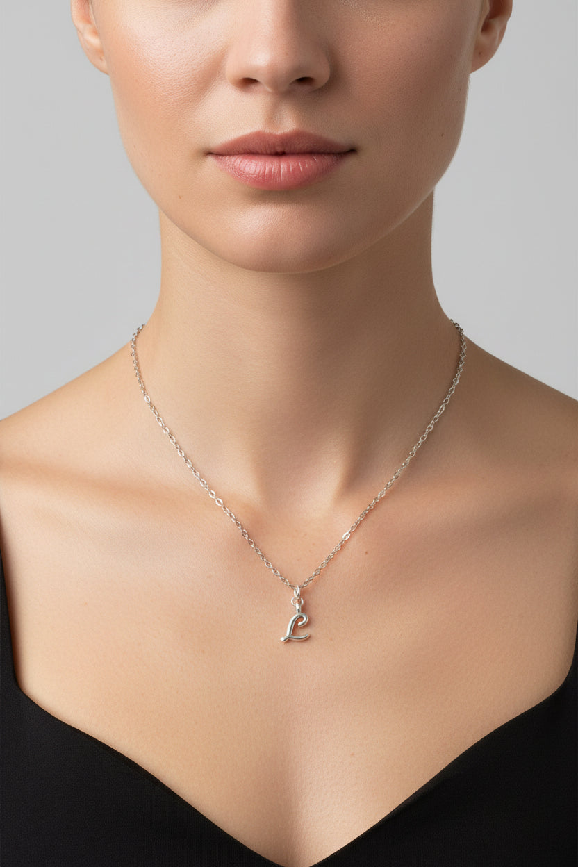 Silver necklace with a 'L' pendant on a mannequin