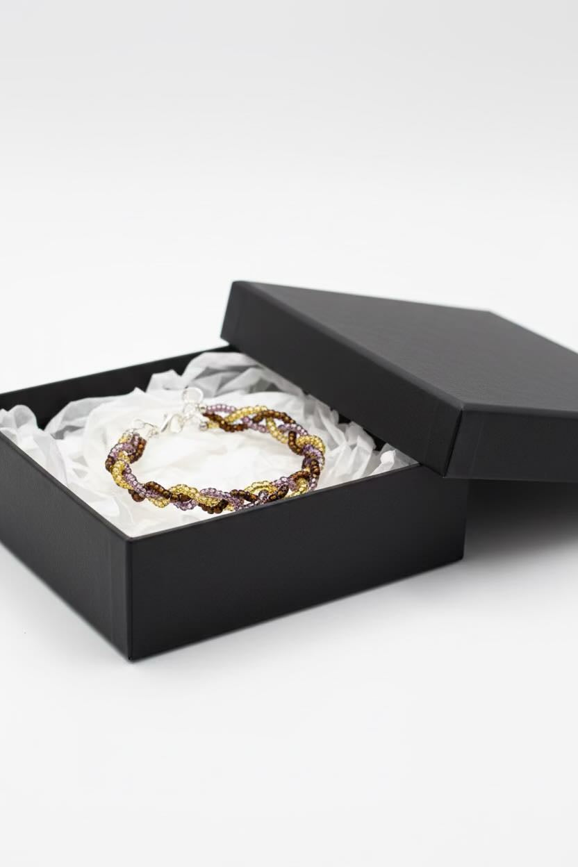 Bracelet inside an open black jewelry box on a white background