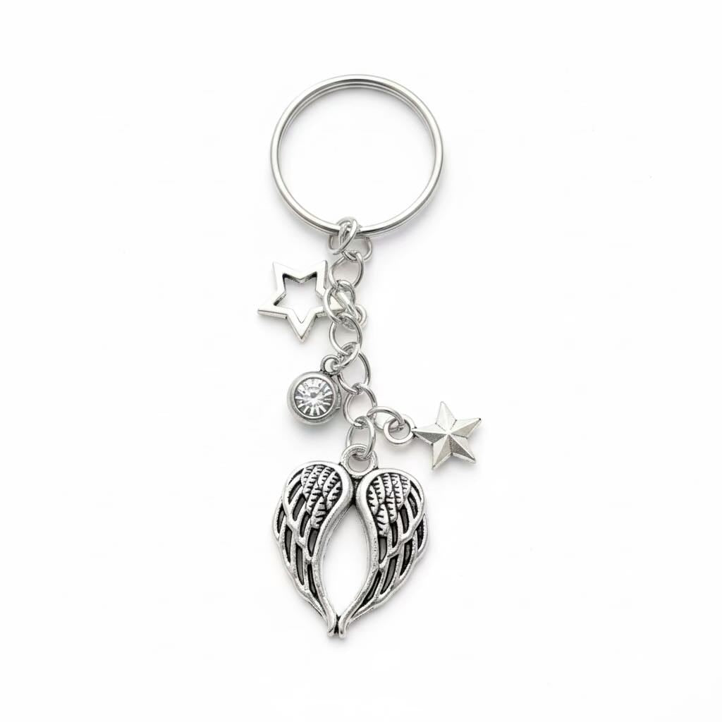 Silver angel wings keyring/keyrings with three star charms and a small angel wings pendant on a white background.