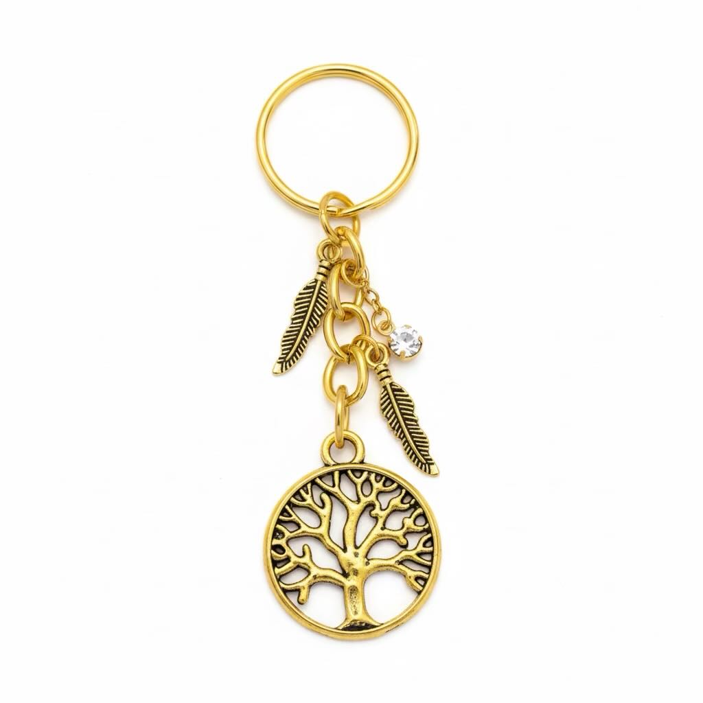 A gold-colored metal keyring featuring a circular tree of life pendant, two feather charms, and a small clear rhinestone, shown on a plain white background.