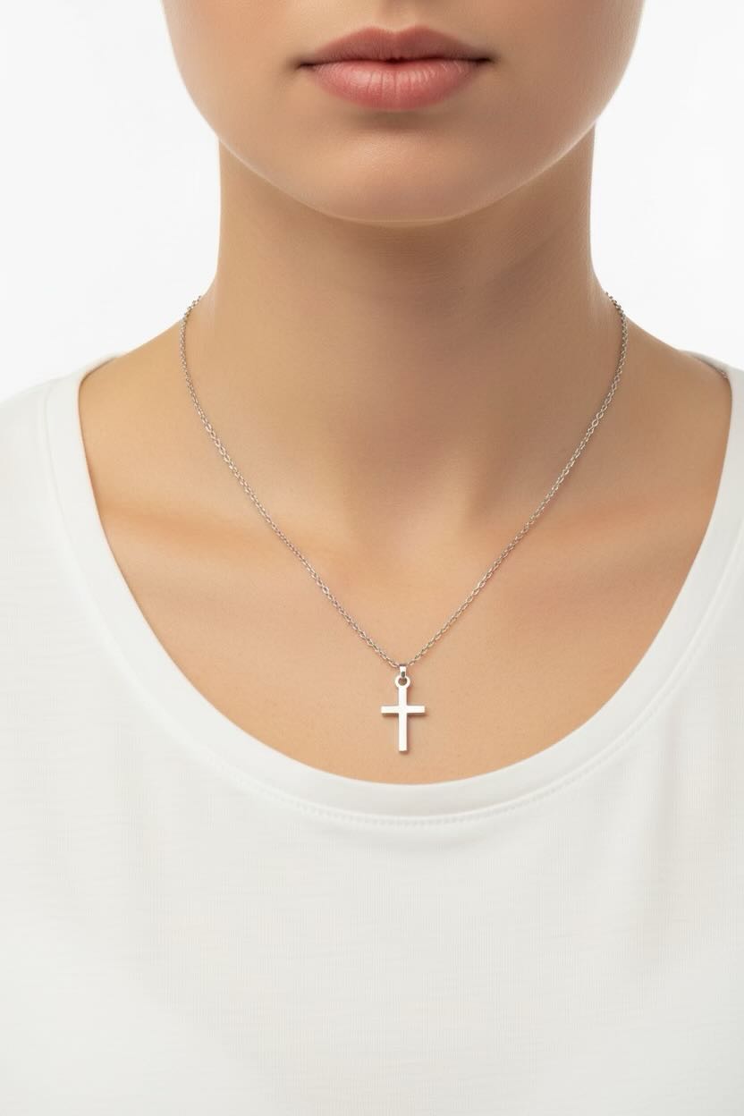 Silver cross necklace on a plain white background
