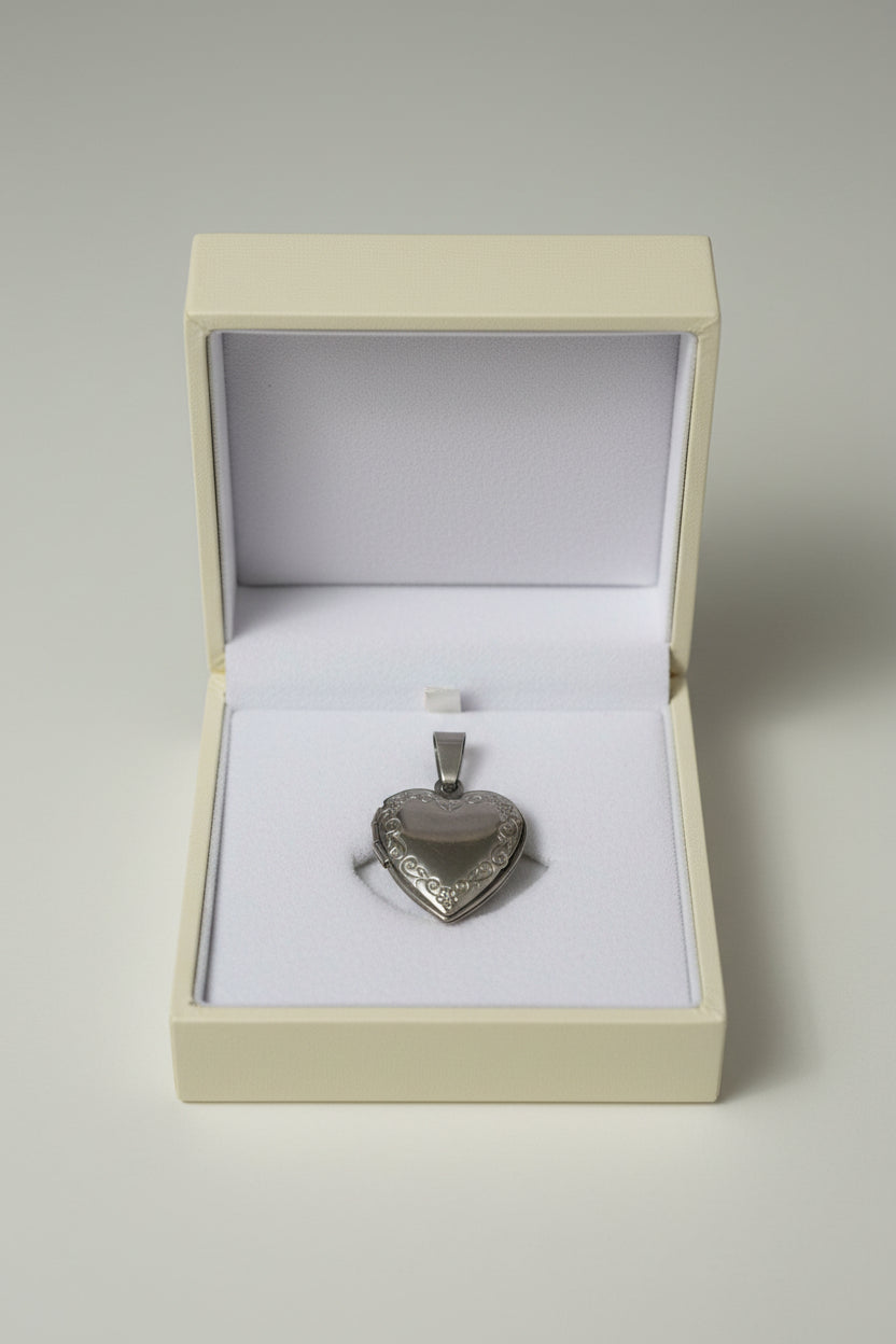 Silver heart-shaped locket in a beige gift box