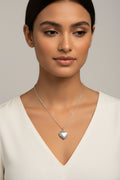 Silver heart-shaped pendant necklace on a model