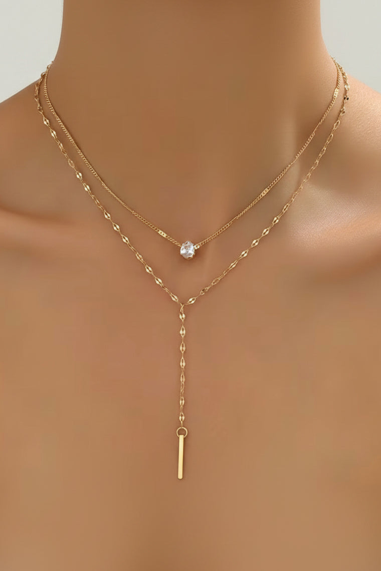 Gold necklace with a pendant on a model