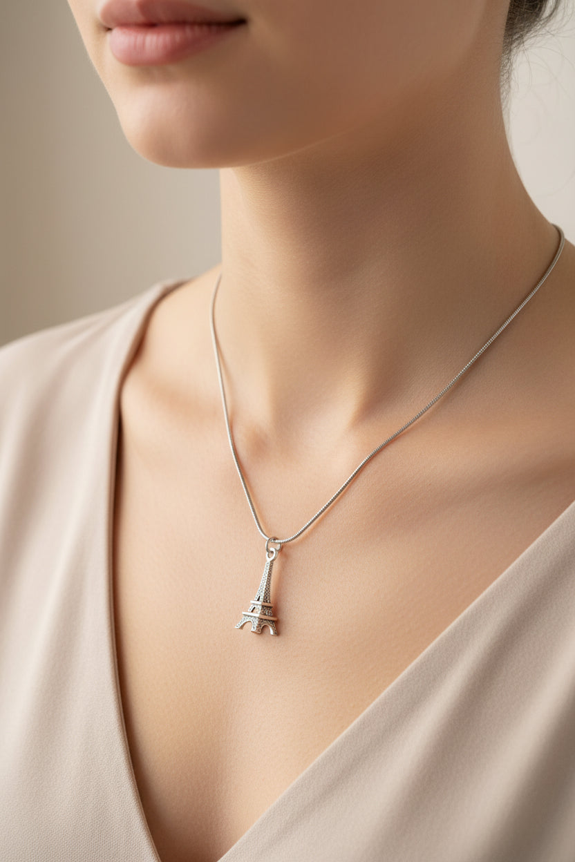 Woman wearing silver eiffel tower necklace 