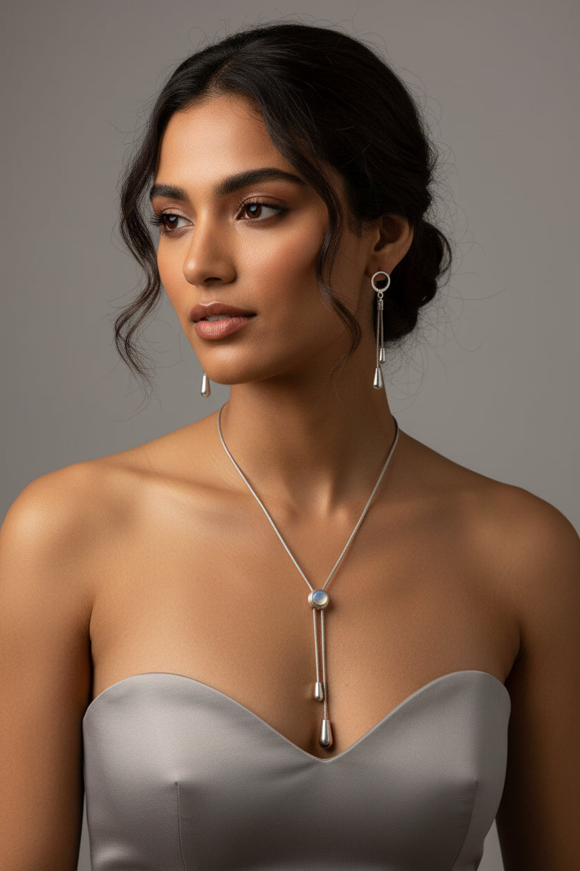Silver necklace and earrings on a model